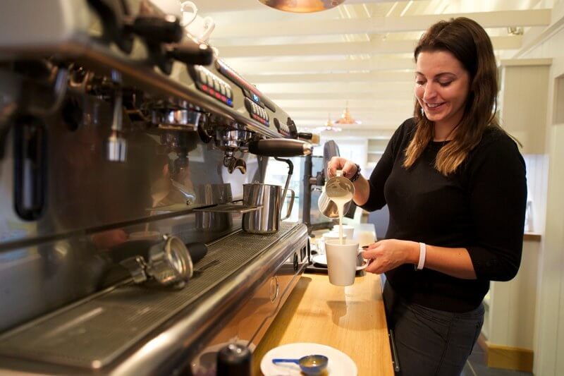 Customer pouring coffee